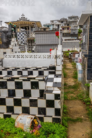 Famous cemetery, many mausoleums or large tombs decorated with tiles, often in black and white.
