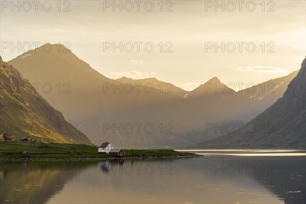 Landscape with sea and mountains on the Lofoten Islands. The fjord Flakstadpollen and some houses