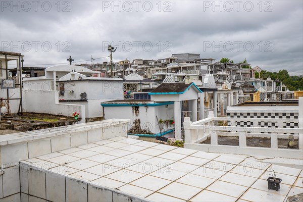 Famous cemetery, many mausoleums or large tombs decorated with tiles, often in black and white.