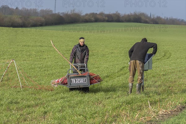 Shepherd and his daughter fence a new pasture with a solar panel for the electric fence,