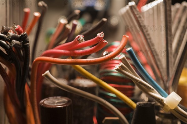 Close-up of cut black, red, yellow, blue and white flexible insulated electrical copper wires,