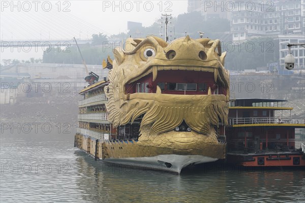 Yichang, Hubei Province, China, Asia, A ship in the shape of a golden dragon's head floats on a