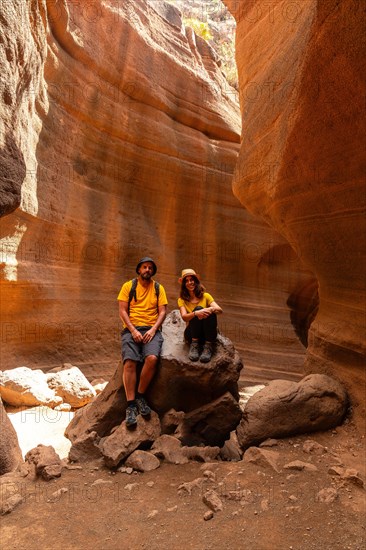 A tourist couple enjoying in the limestone canyon Barranco de las Vacas in Gran Canaria, Canary