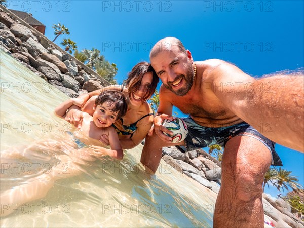 Selfie of a family on vacation on a beach in the Canary Islands. Concept of happy family outdoors.