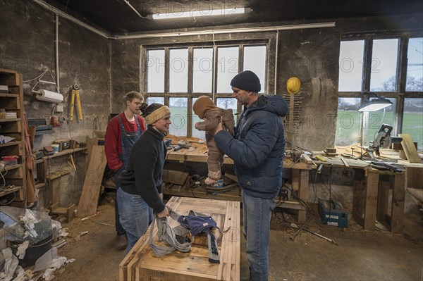 Family reunion in the workshop, father, daughter, son and grandson, Mecklenburg-Vorpommern,