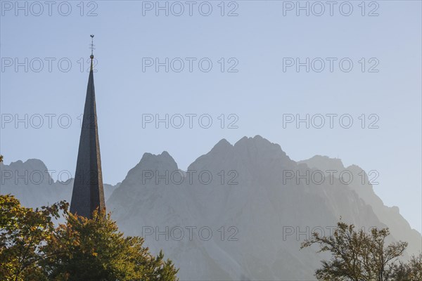 Old parish church of St Martin in the evening light, Wetterstein mountains with Zugspitze massif,