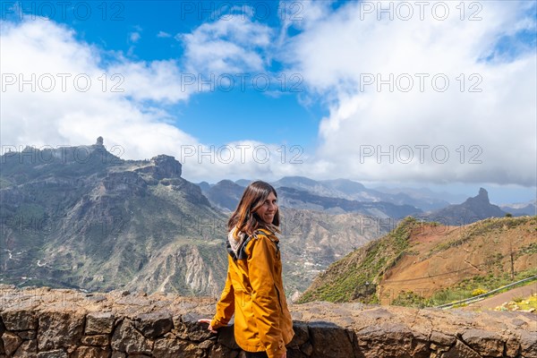 Portrait of a woman looking at Roque Nublo from a viewpoint on the mountain. Gran Canaria, Spain,