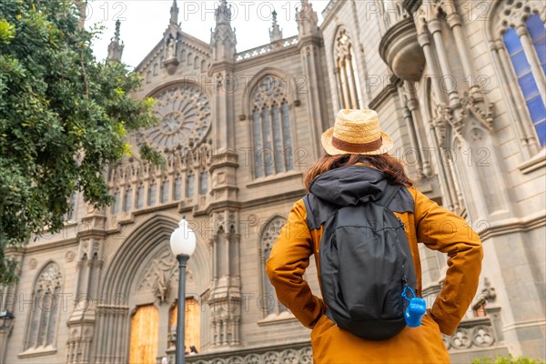 A tourist with a hat visiting the Church of San Juan Bautista, Arucas Cathedral, Gran Canaria,