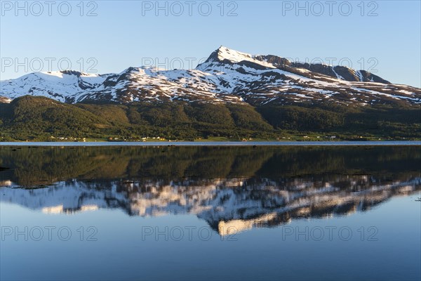 Landscape in Norway. The Balsfjord with a view of Mount Fugltinden. At night during the midnight