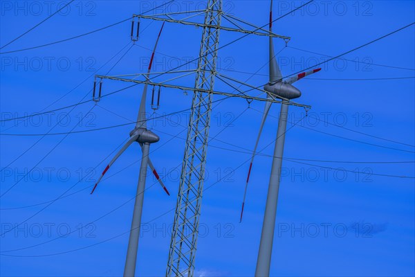 Wind energy in an inclined position, theme photo, electricity pylon with high-voltage lines and