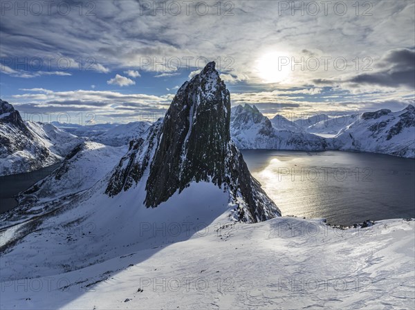 Aerial view of Bergen by the sea, fjord, sunbeams, winter, snow, Mount Segla, Senja, Troms,