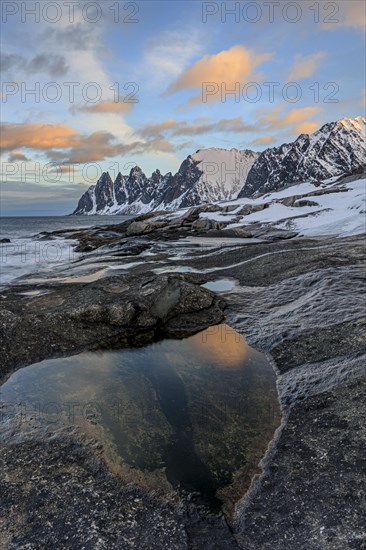 Rocky coast in front of Bergen, sea and pond, morning mood with clouds, winter, Tungeneset, Senja,