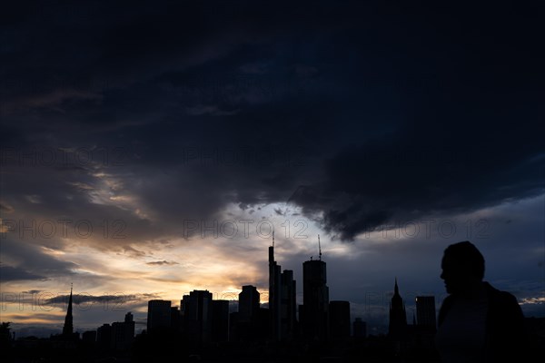 Dense clouds pass over the Frankfurt banking skyline in the evening, Floesserbruecke, Frankfurt am