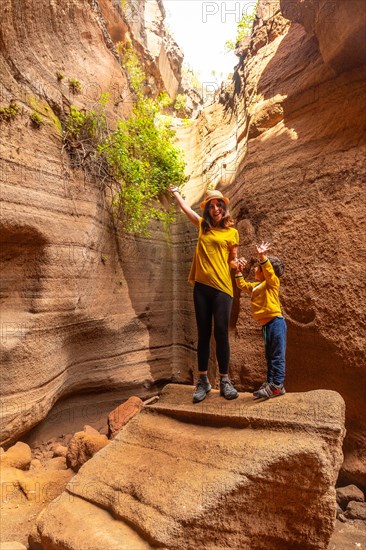 Family on vacation enjoying in the limestone canyon Barranco de las Vacas in Gran Canaria, Canary