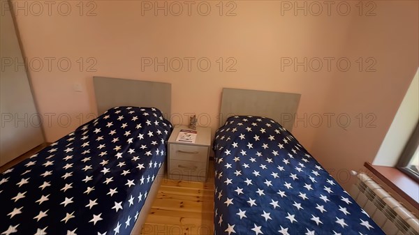 Interior of a hotel room with double bed in the American flag