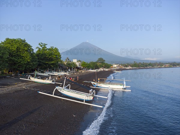 Fishermen loading fish from their outrigger boats in the morning on the black beach of Amed, Amed,
