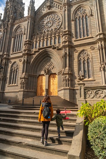 A mother with her son visiting the Church of San Juan Bautista, Arucas Cathedral, Gran Canaria,
