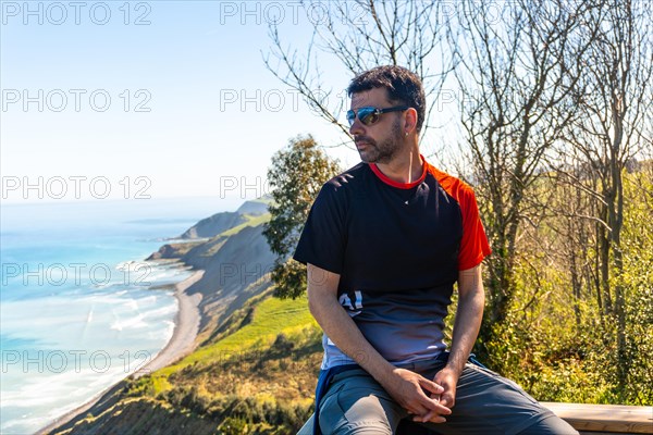 Portrait of a man looking at the beautiful coastal landscape in the flysch of Zumaia, Gipuzkoa.