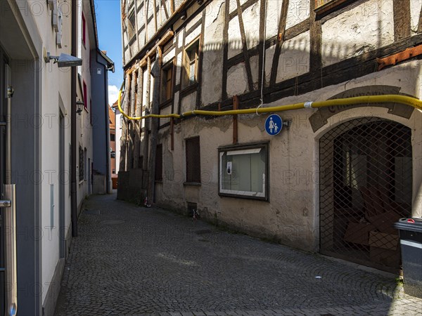View through the Trinklaube, a winding narrow alley in the old town of Wangen im Allgaeu, Upper