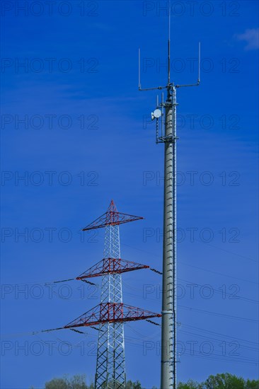 Electricity pylon with high-voltage lines and mobile phone mast near the Avacon substation