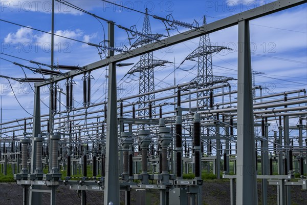 Power pylons with high-voltage lines and insulators at the Avacon substation in Helmstedt,