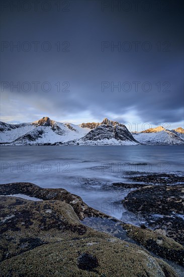 Rocky coast off Bergen, sea, waves, spray, morning mood with clouds, long exposure, winter,
