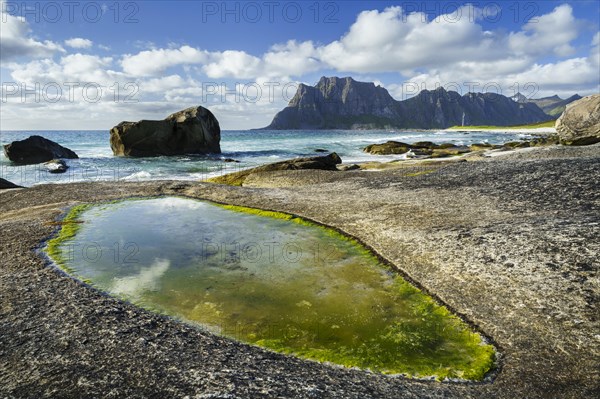Seascape on the beach at Uttakleiv (Utakleiv), in the foreground rocks and a rocky outcrop filled