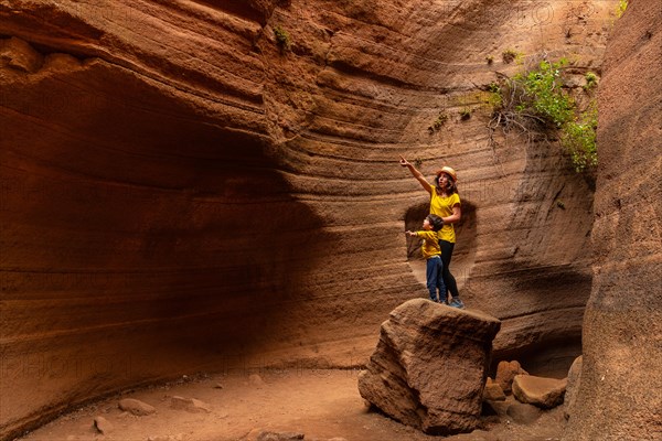 Mother and son enjoying in the limestone canyon Barranco de las Vacas in Gran Canaria, Canary
