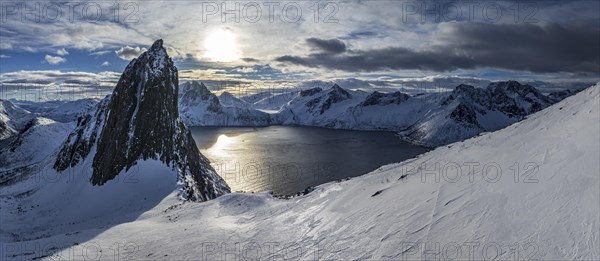 Aerial view of Bergen by the sea, fjord, sunbeams, winter, snow, panorama, Mount Segla, Senja,