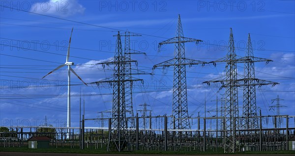 Wind turbine and high-voltage pylons at the Avacon substation in Helmstedt, Helmstedt, Lower
