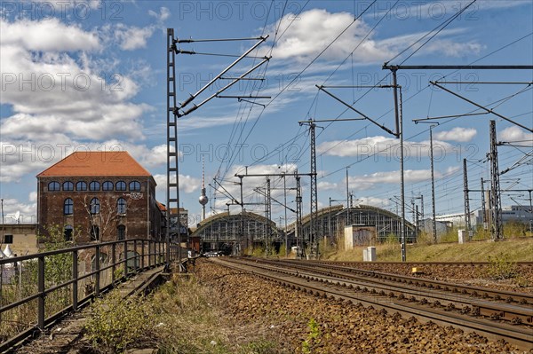 In the foreground, the railway tracks and Postbahnhof Berlin building and the Ostbahnhof station