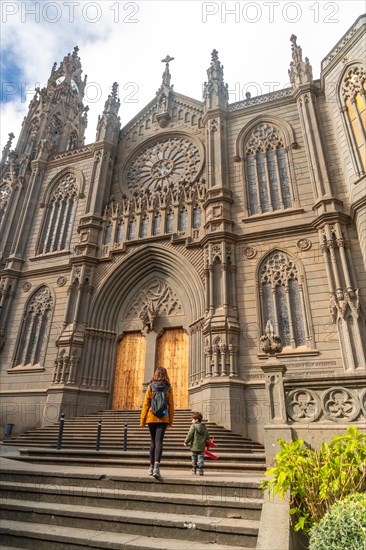 A mother with her son visiting the Church of San Juan Bautista, Arucas Cathedral, Gran Canaria,