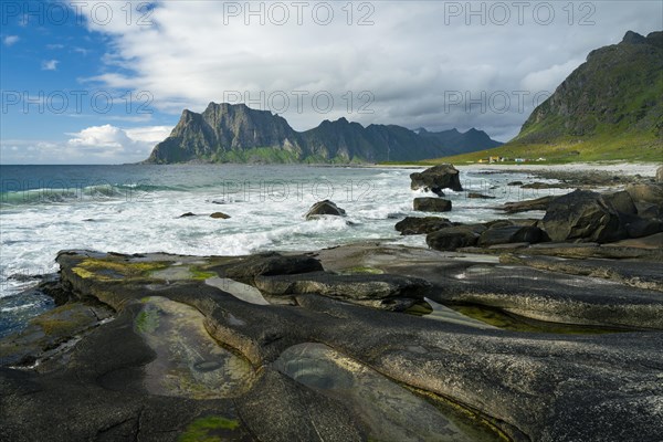 Seascape on the beach at Uttakleiv (Utakleiv), in the foreground rocks and rocky outcrops filled