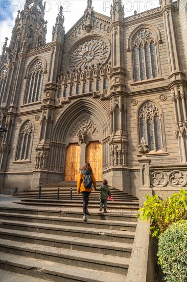 A mother with her son visiting the Church of San Juan Bautista, Arucas Cathedral, Gran Canaria,