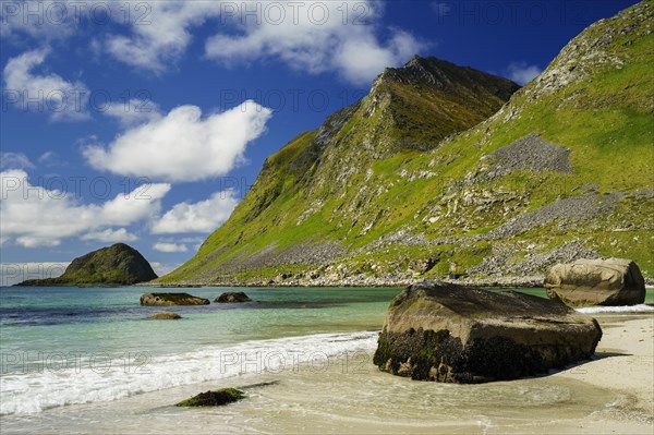 Landscape with sea at the sandy beach of Haukland (Hauklandstranda) with the mountain Veggen. Some
