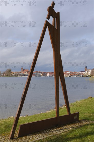 The raftsman, sculpture by Roman Peter, view of Waren with St Georgen's Church and St Mary's