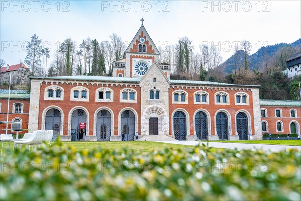 Old salt worksWide-angle shot of a Gothic church with brick facade in front of a hilly landscape,