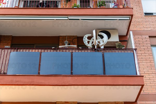 Balcony power plant and mini wind turbine on a balcony of a high-rise building in Barcelona, Spain,