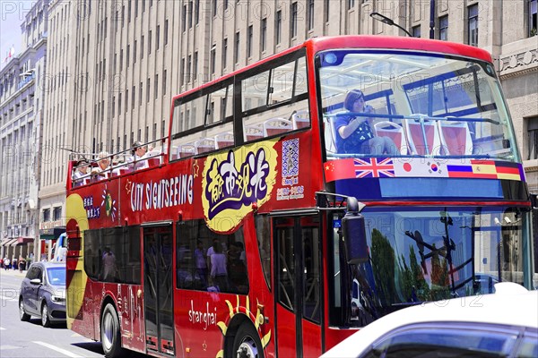 Shanghai, Sightseeing double-decker bus with colourful design drives through the city, Shanghai,