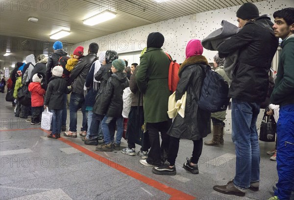 Refugees have arrived at Schoenefeld station on an IC train. They are then taken by bus to