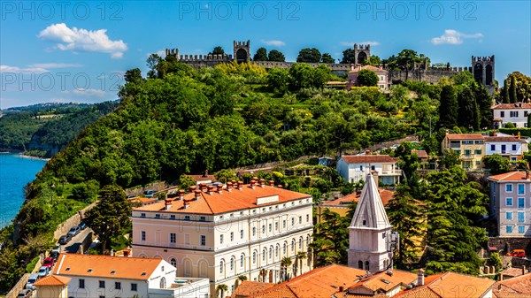 View from the bell tower over Piran with city walls and castle, harbour town of Piran on the