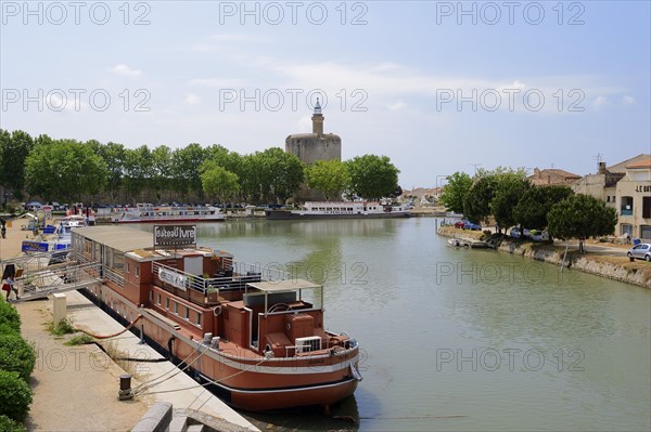 Ship in the harbour and Tour de Constance fortified defence tower, Aigues-Mortes, Camargue, Gard,