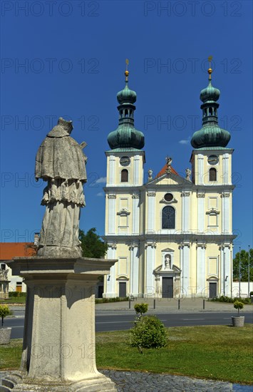 Double-tower facade of the Basilica of the Nativity of the Virgin Mary with Marian column, Roman