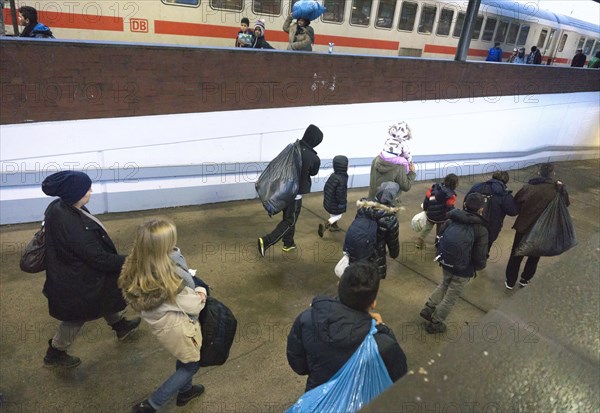 Refugees have arrived at Schoenefeld station on an IC train. They are then taken by bus to