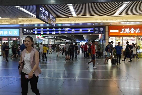 Hongqiao Railway Station, Shanghai, China, Asia, People walking past various shops in a busy