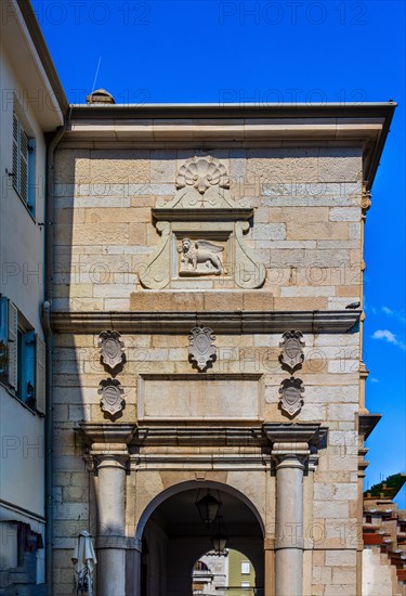Old town alley with Venetian lion at the gate, harbour town Piran on the Adriatic coast with