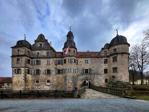 Mitwitz moated castle under a cloudy sky. Mitwitz, Kronach, Upper Franconia, Bavaria, Germany,