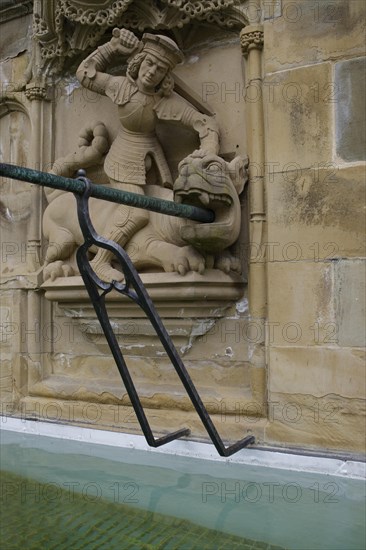 Dragon slayer motif on the fish fountain, dragon, sword, fountain, market fountain, old town,