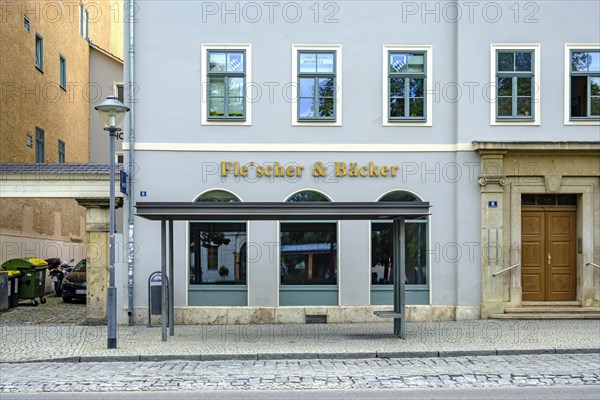 Butcher and baker in one, that's rare, exterior view of a house with the shop sign butcher &
