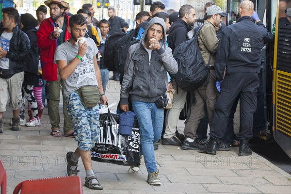 Syrian refugees have arrived at Schoenefeld station on a special train. They are then taken by bus